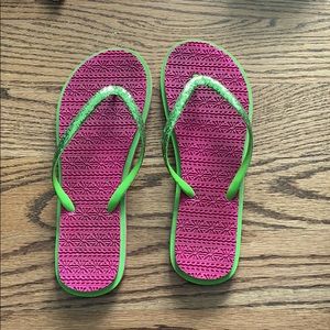 Pink and green flip flops